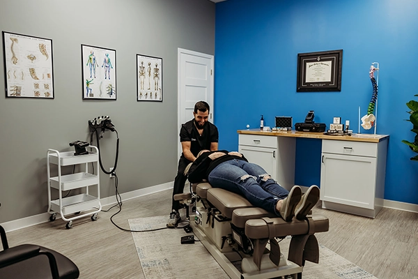 Chiropractor Alexander Dalton Adjusting A Patient