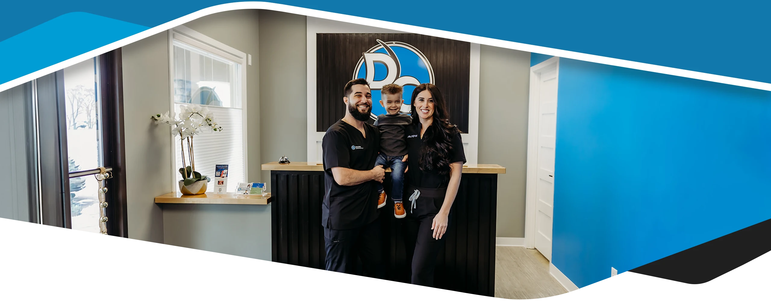 Chiropractor Alexander Dalton With Staff And Smiling Patient